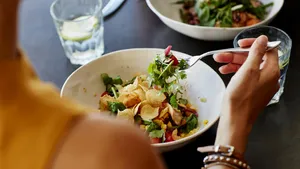 Woman having food at restaurant table