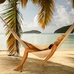 bikini woman napping in a hammock at the Caribbean beach