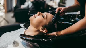 Beautiful young woman getting a hair wash. Hair salon styling concept.