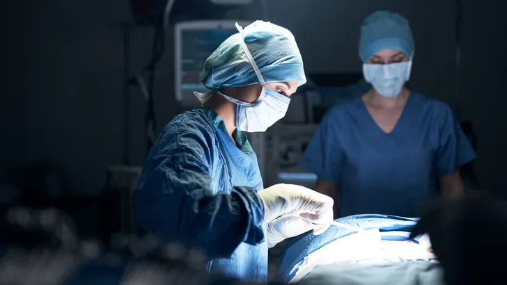 Shot of surgeons performing surgery in an operating theatre