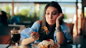 Woman Feeling Sick While Eating Huge Meal