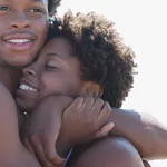 Smiling couple hugging outdoors