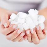 Woman holds in hands of sugar cubes