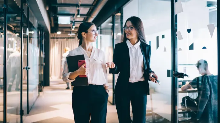 Female executives having free time and gossiping at office hall