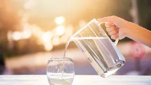 Pouring Water From Pitcher Into Glass