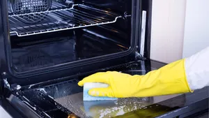 Woman cleaning oven