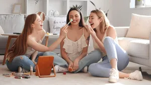 Young women doing makeup at home