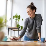 Creative young woman working on laptop in her studio