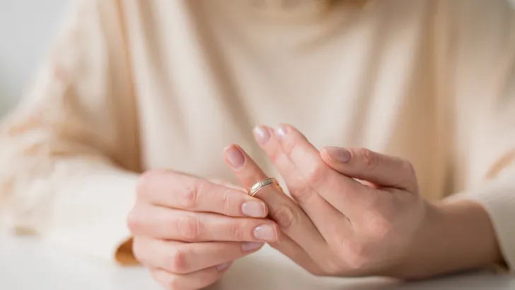 Woman divorcing and taking off wedding band