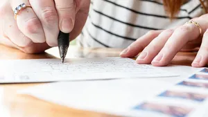 Woman Writing on a Postcard