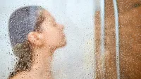 Woman take a shower at home.