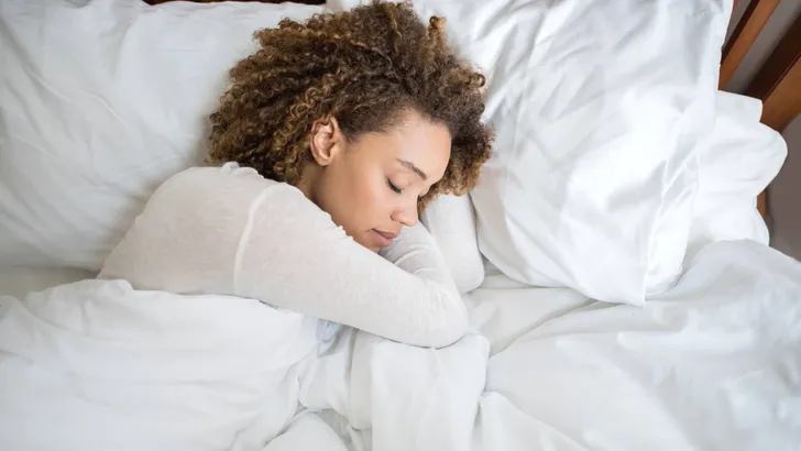 African American woman sleeping in bed