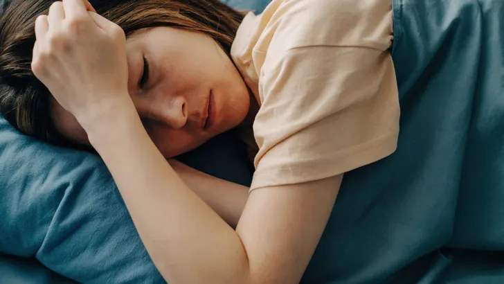 Sad woman lying in bed with a depressed state.