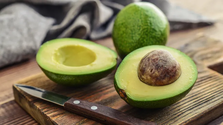 Fresh avocado on cutting board