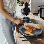 Anonymous Woman Pouring Hot Water to Make Tea for Breakfast in the Kitchen, a Close Up