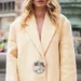 Vrouw in oversized butter yellow blazer tijdens Copenhagen Fashion Week - trends