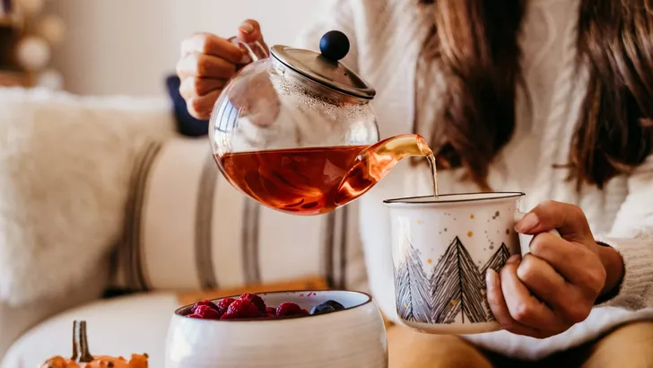 woman having a cup of tea at home during breakfast. Cute golden