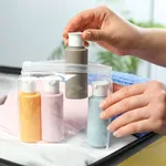 Woman with plastic bag of cosmetic travel kit packing suitcase, closeup