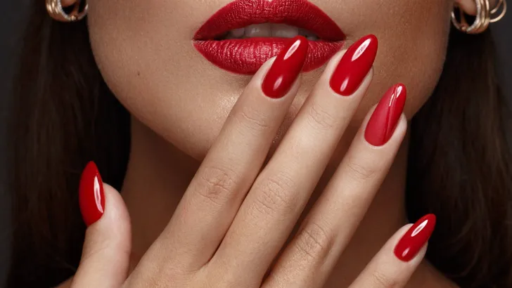 Beautiful girl with a classic make-up and red nails. Manicure design. Beauty face.