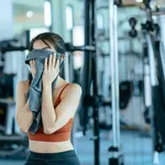 sport woman resting after workout and wipe the sweat by towel. s