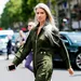 Sarah Harris met grijs lang haar op straat in groen pak