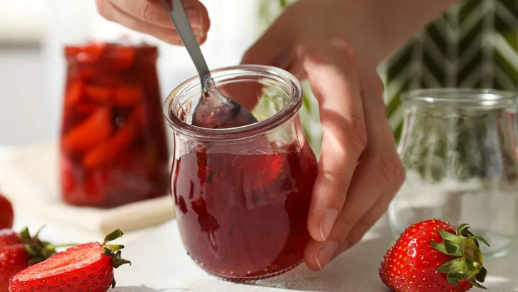 Concept of cooking tasty and sweet food - strawberry jam