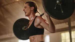 Strong woman exercising with heavy weights