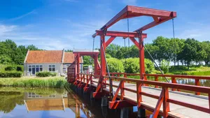 Red wooden bridge in historic village Bourtange