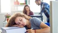 Stressed Woman Sleeping In Office