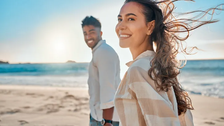 Shot of a young couple spending time together at the beach