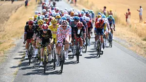 Deelnemers Tour de France met Jonas Vingegaard, Tim Wellens in de bollentrui en Tadej Pogacar in de gele trui voorop in het peloton.