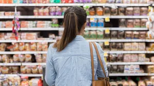 Unrecognizable woman marvels at grocery bread selection