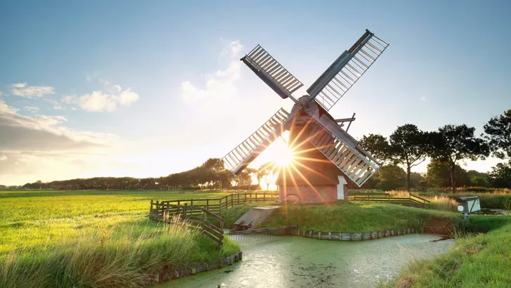 sunshine behind Dutch windmill