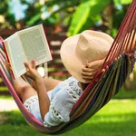 Woman reading book in hammock