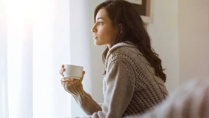 Woman thinking at home