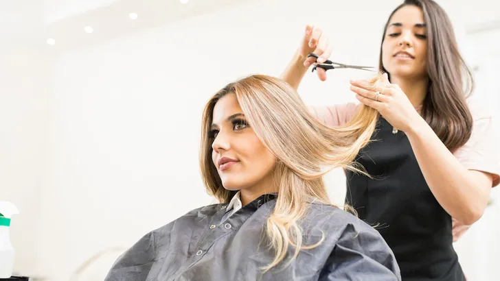 Hairdresser cutting some hair tips