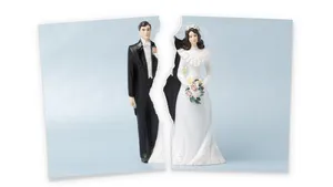 Divorce.Torn photograf of wedding cake topper