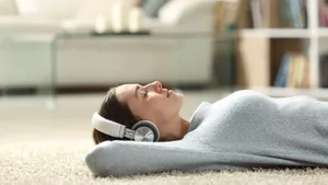 Relaxed woman listening to music with headphones at home