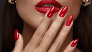 Beautiful girl with a classic make-up and red nails. Manicure design. Beauty face.