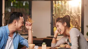 Laughing Couple on Date in Cafe
