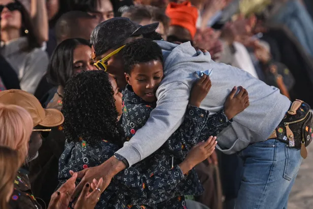 Pharrell Williams knuffelt met familie tijdens show Louis Vuitton Runway in Parijs 2026. 