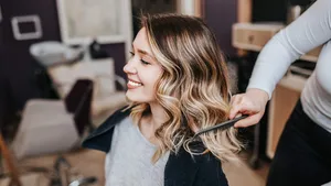 Beautiful young woman with perfect hairstyle satisfied after dye