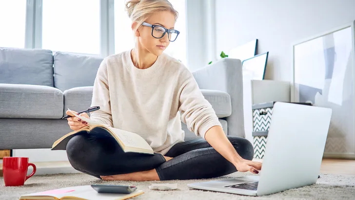 Woman using laptop paying bills online and managing home budget