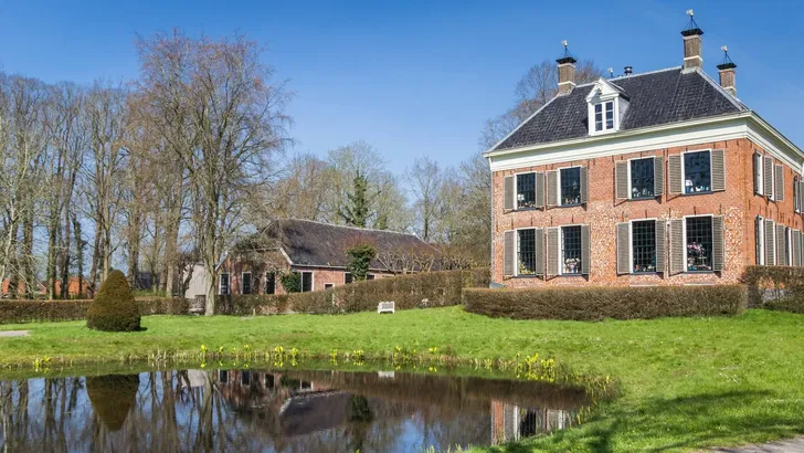 Panorama of the historic mansion Ennemaborg and pond in Midwolda, Netherlands