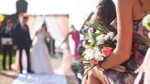 Wedding ceremony outdoors, focus on flowers bouquet