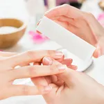 Manicure with buffer at nail salon