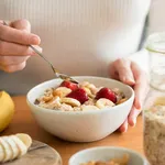 Woman eating oatmeal porridge