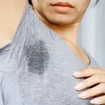 Asian Woman having problem sweat armpits because of hot weather