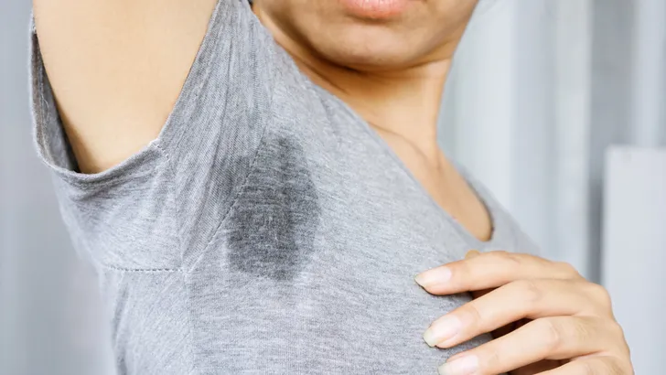 Asian Woman having problem sweat armpits because of hot weather