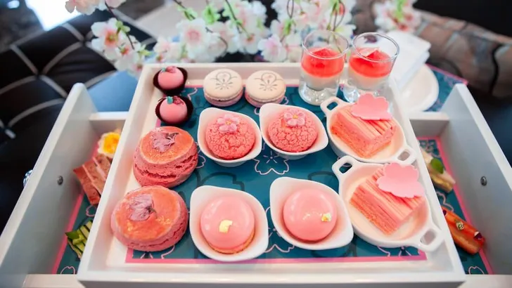 Sweet pastel peach and pink colorful set of afternoon tea in Sakura or Cherry Blossom theme. Tasty and delicious dessert, savories, bakery and pastry. Good for high tea party or Birthday celebration.